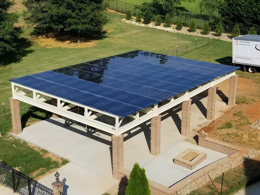 A pergola with a solar panel roof.